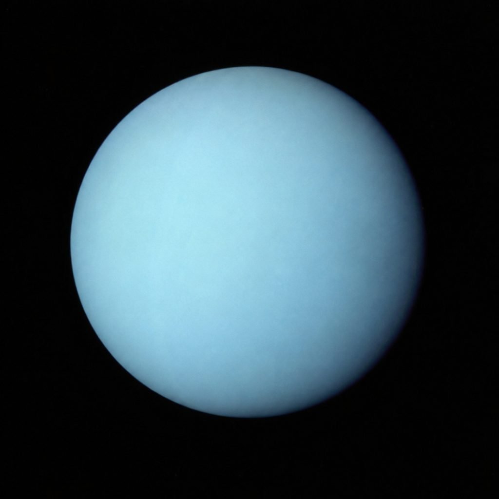 A pale blue image of planet Uranus captured by the Voyager 2 spacecraft in 1986